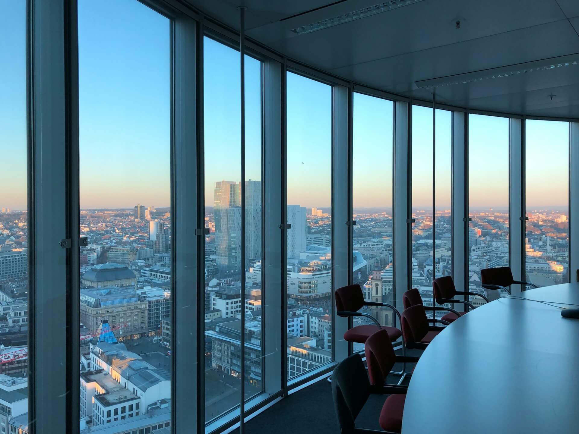 Empty boardroom with view of city from corner window